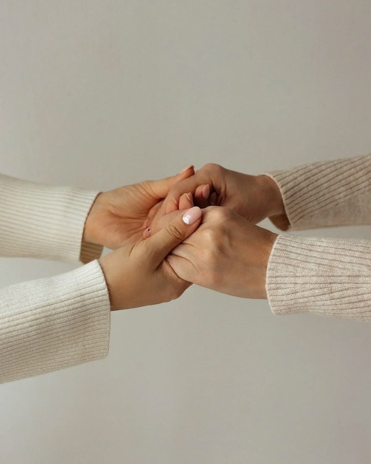 Hands held in support — a safe space to begin again at Mindtone