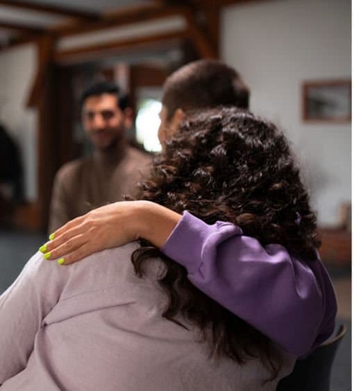 People supporting each other in a therapy session